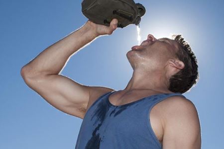 man drinking water from a bottle