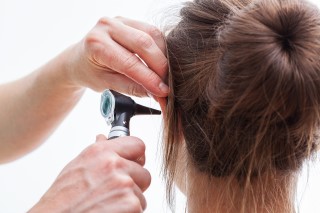 Doctor looking inside of an ear