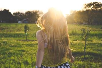 Woman running through the grass